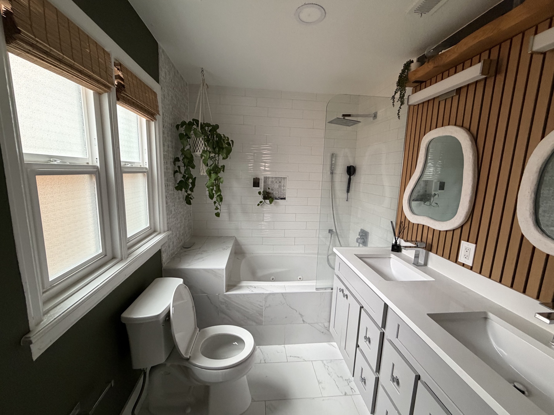 Remodeled bathroom with wood-slat wall and soaking tub